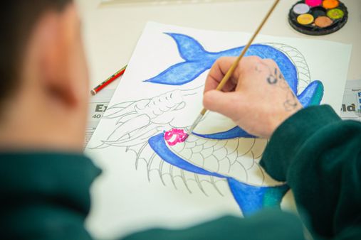 A person in prison taking part in an art class