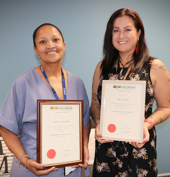 Rebecca and Maddie hold up the certificates awarded from the programme